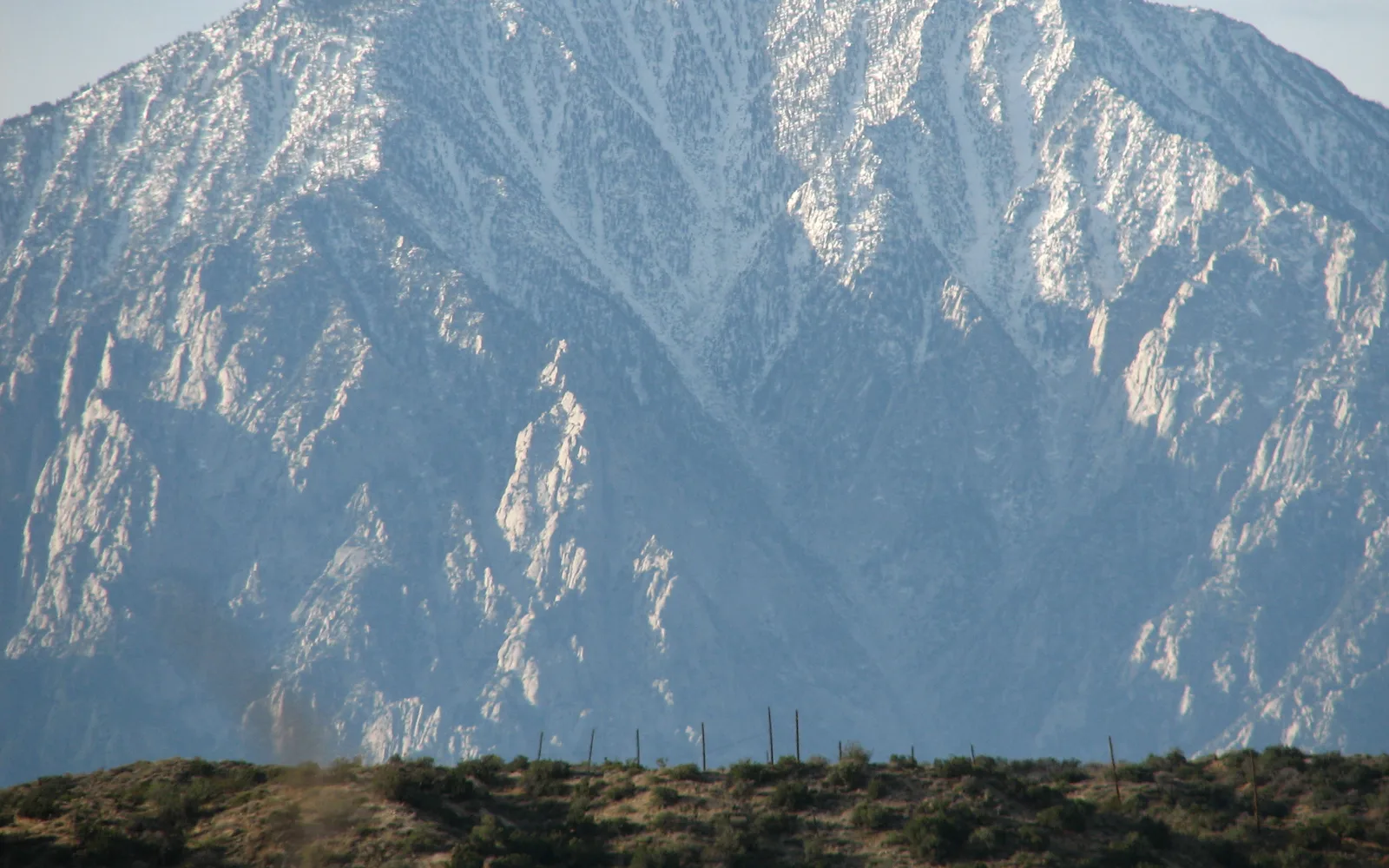 San Jacinto Peak viewed from below, rising above the surrounding landscape beneath a clear sky